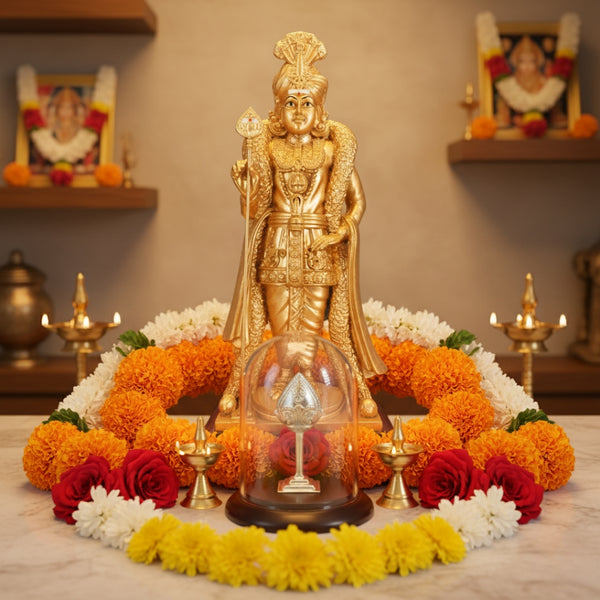 Gold-colored Palani Raja Alangara Murugan statue on a decorative table with Silver Vel