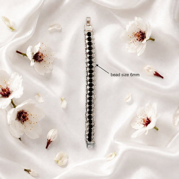 Close-up of 6mm authentic Karungali ebony wood beads integrated into a handcrafted white metal setting.