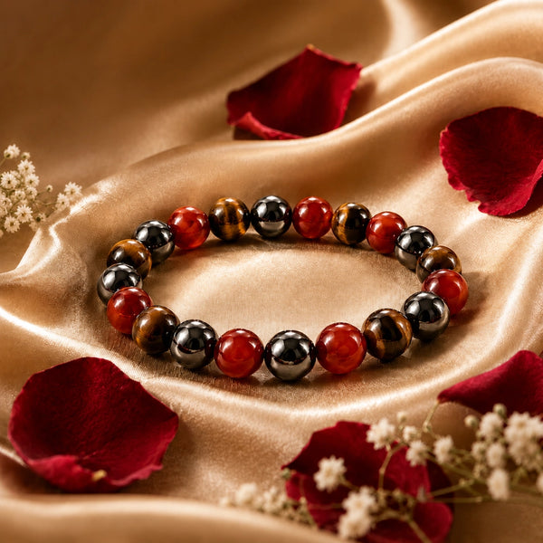 Multicolored beaded bracelet on a beige fabric background with red petals and white flowers.