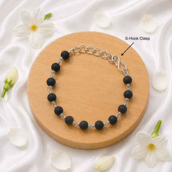 Detail of the secure S-hook clasp and adjustable silver-toned extension chain on an authentic Karungali wood bracelet.