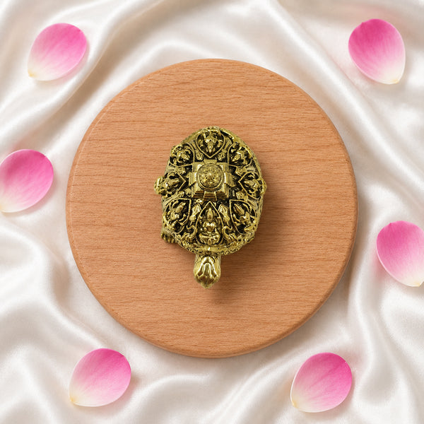 Extreme close-up of the brass Ashtalakshmi Kurma shell, revealing the fine craftsmanship of the eight Lakshmi deities.