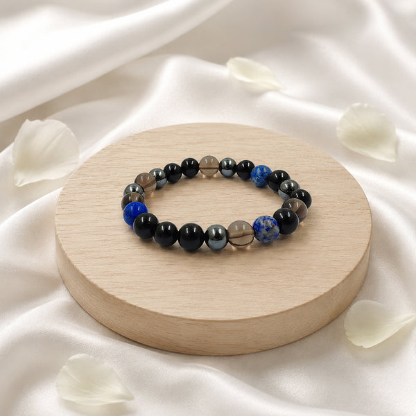 Angled view of the Shani Shakti crystal bracelet highlighting the vibrant blue lapis lazuli and dark grounding stones.