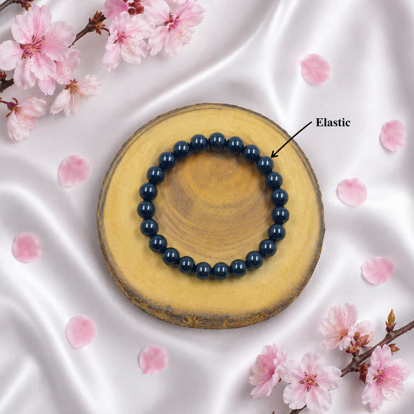 Detailed view of the high-durability elastic stretch cord on a genuine 8mm Black Agate protection bracelet.