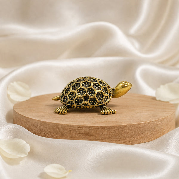 Side profile of the solid brass tortoise highlighting the antique gold finish.