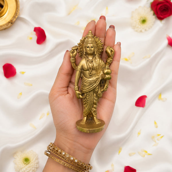 Handheld shot of the 4.9-inch gold-finished Dhanvantri statue to show scale.
