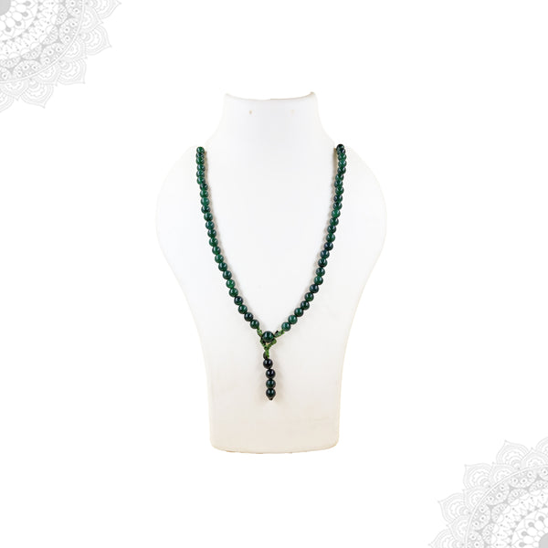 A deep green jade crystal mala necklace worn doubled over a white jewelry mannequin bust to showcase its rich color and length