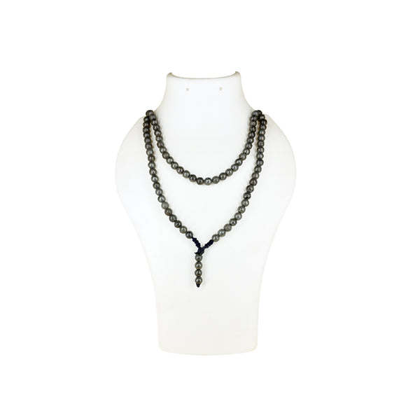 A Pyrite crystal prayer mala necklace worn doubled on a white jewelry display bust, showcasing the metallic sheen and density of the beads.
