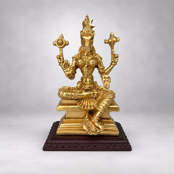 Fiber resin Varahi Amman statue placed in a pooja room with brass lamps and jasmine garlands