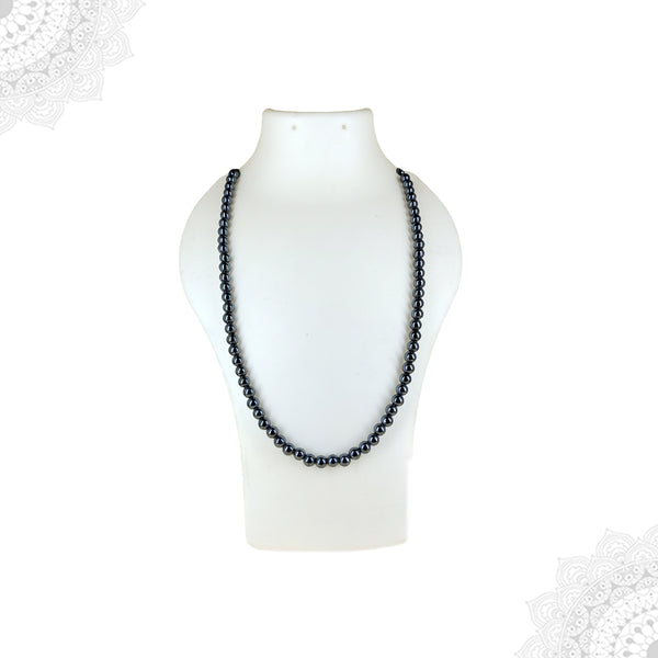 A long Hematite crystal mala necklace featuring shiny metallic dark grey beads displayed on a white jewelry mannequin bust