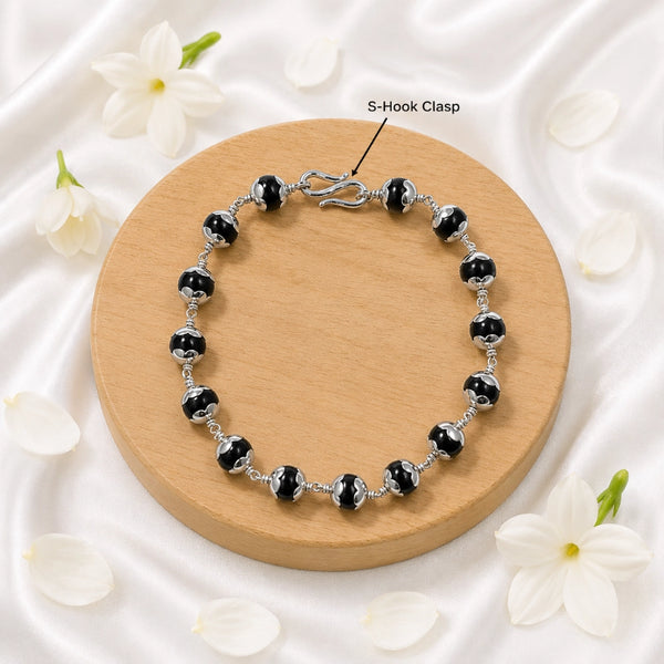 Close-up of the traditional secure S-hook metal clasp on a premium Karungali ebony wood bracelet.