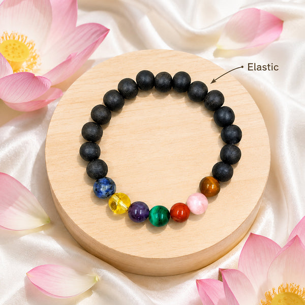 Detail of the high-durability elastic stretch cord on a genuine 7 Chakra Karungali wood manifestation bracelet.