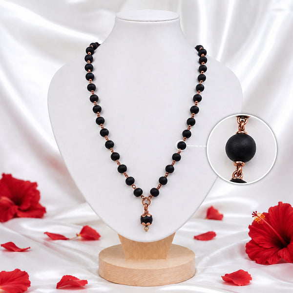 Handcrafted Karungali Mala with Copper Finish and Natural Black Karungali Wood Beads on Wooden Display