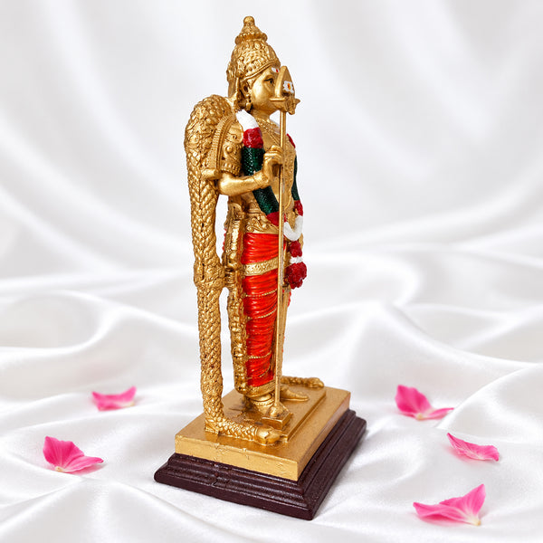 Side view of Malaysian Murugan statue showing the vel and the wooden base