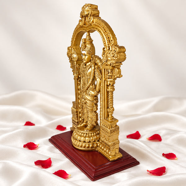 Left side view of gold Murugan statue showing the temple arch, pillars and lotus base