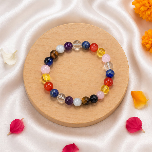 Side view of the Navratri 9-color spiritual bracelet displayed with traditional marigold and lotus petals.