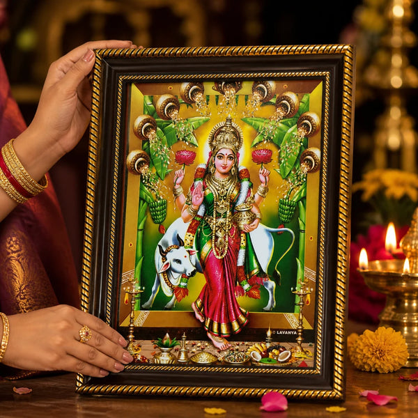 Close-up of the Lakshmi photo frame held by hand, showcasing the intricate golden ornate border and high-definition vibrant colors of the spiritual artwork.