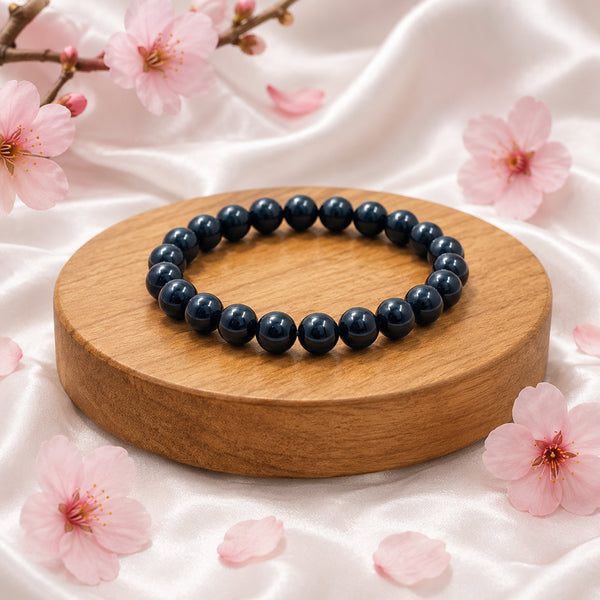Premium Black Agate crystal bracelet on a wooden display for grounding, protection, and Root Chakra healing.