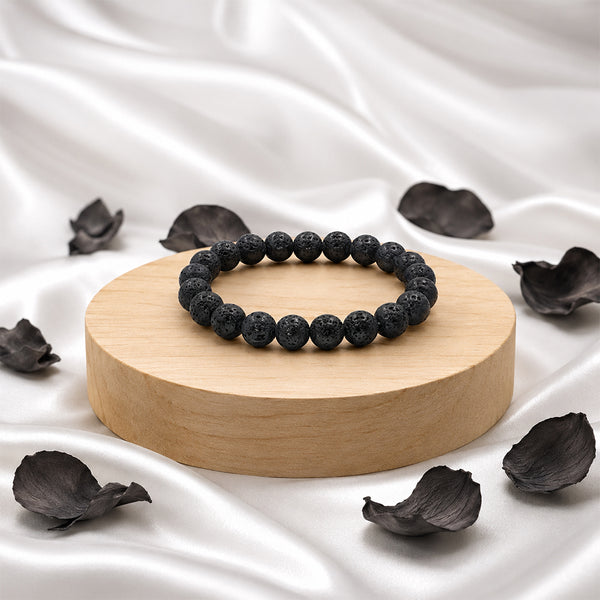Premium black Lava Stone bracelet on a wooden display, used for grounding energy and essential oil aromatherapy