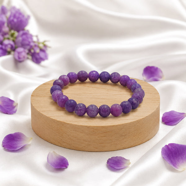 Premium Lepidolite crystal bracelet on a wooden display, known as the stone of transition and emotional healing.