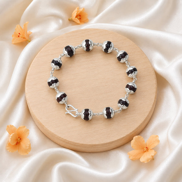 Premium Red Sandalwood (Lal Chandanam) bracelet featuring silver-toned capped beads and a traditional secure S-hook clasp.