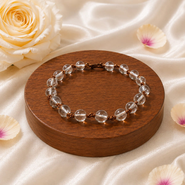 Premium Spadigam Sphatik bracelet displayed on a wooden base surrounded by rose petals for a luxury aesthetic
