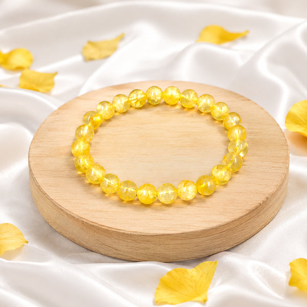 Premium yellow citrine crystal bracelet on a wooden display, known for attracting wealth and financial success.