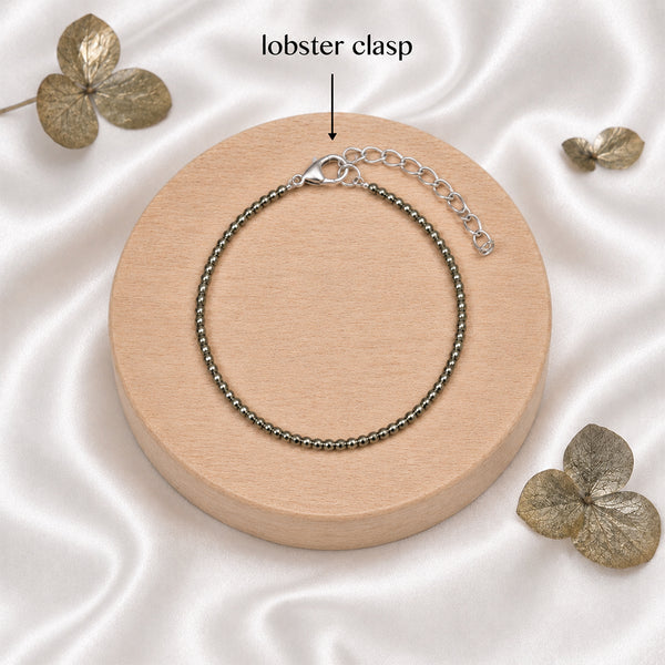 Detailed view of the secure silver-toned lobster clasp and adjustable extension chain on a Pyrite crystal manifestation bracelet.
