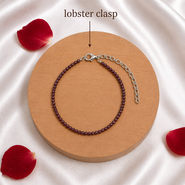 Detailed view of the secure silver-toned lobster clasp and adjustable extension chain on a Red Garnet healing bracelet.