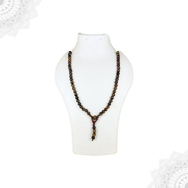 A long Tiger's Eye crystal mala necklace with round, banded brown and gold beads displayed on a white jewelry mannequin bust.