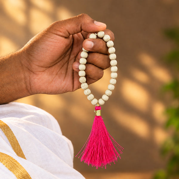 Tulsi japamala with pink silk tassel held in hand for Perumal japa chanting