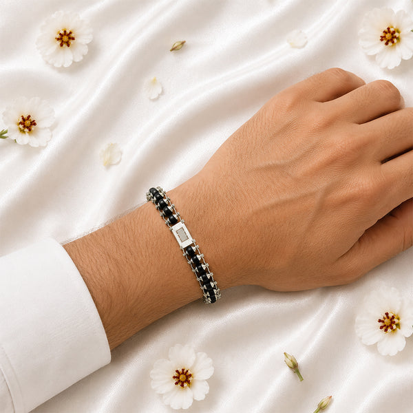 A person wearing the artisanal Karungali and white metal architectural bracelet, showing its high-end spiritual style.