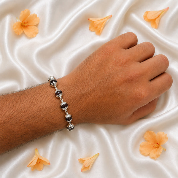 Detailed view of the traditional secure S-hook metal clasp on a silver-capped Red Sandalwood bead bracelet.