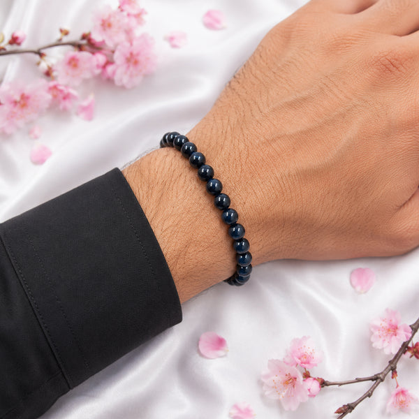 A person wearing the glossy 8mm Black Agate bead bracelet for mental stability and aura protection.