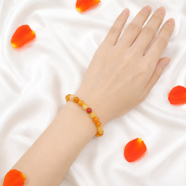 A person wearing the 8mm Carnelian bead bracelet to boost confidence and sacral chakra alignment.