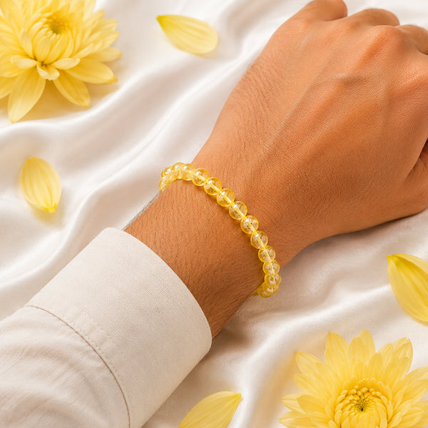 A person wearing the 8mm yellow citrine crystal bracelet to align with the energy of abundance and joy.