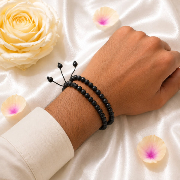 A person wearing the set of two original Karungali ebony wood bracelets for doubled spiritual protection.
