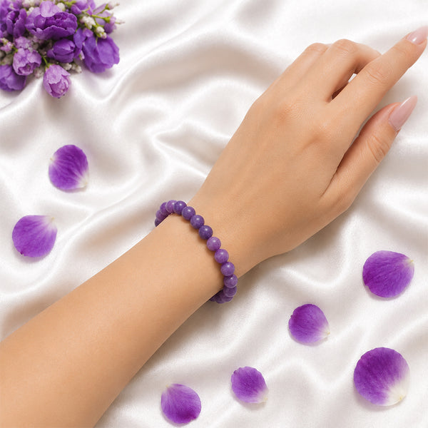 A person wearing the 8mm Lepidolite bead bracelet to align with the energy of calm and third eye activation.