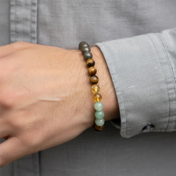 A person wearing the 8mm Money Magnet gemstone bracelet for manifesting wealth and prosperity.