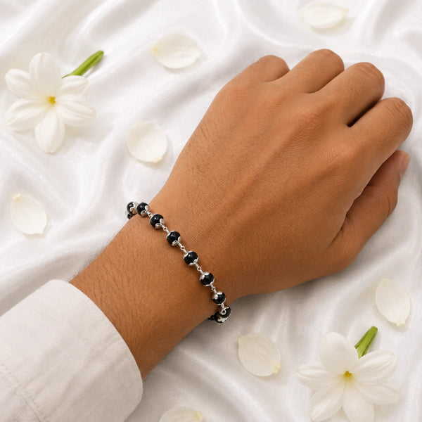 A person wearing the luxury silver-capped Karungali bracelet, showcasing its elegant and protective spiritual design.