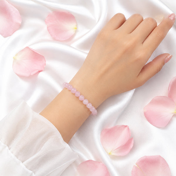A person wearing the 8mm Rose Quartz bead bracelet to align with the energy of compassion and self-love.