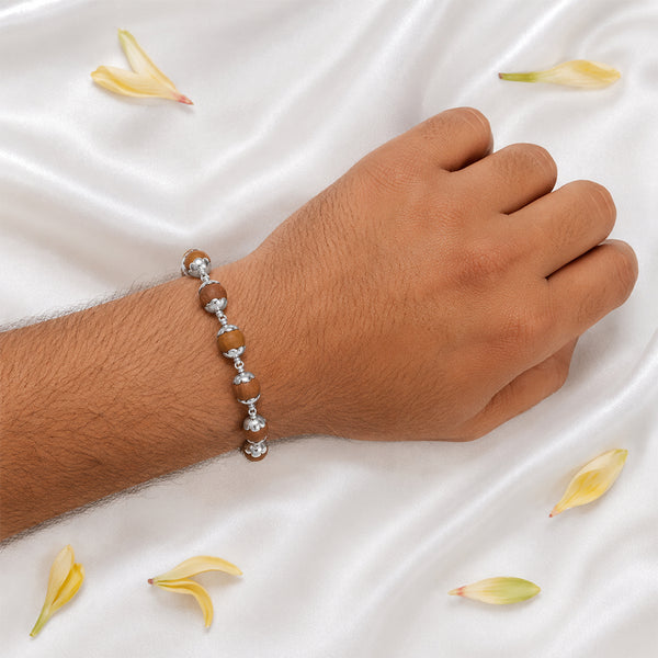 A person wearing the premium silver-capped Sandalwood bracelet, showcasing its elegant design for peace and meditation.