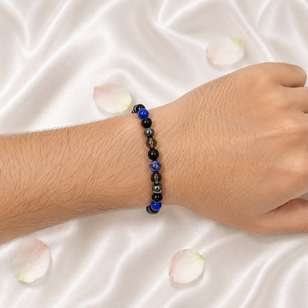 A person wearing the Shani Shakti stretchable crystal bracelet on their wrist for spiritual protection and grounding.
