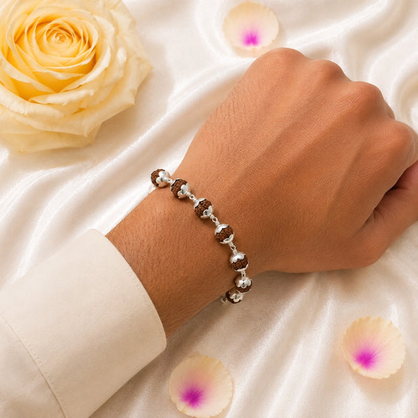 A person wearing a silver-capped original Rudraksha bracelet, showcasing a stylish and spiritual healing accessory.