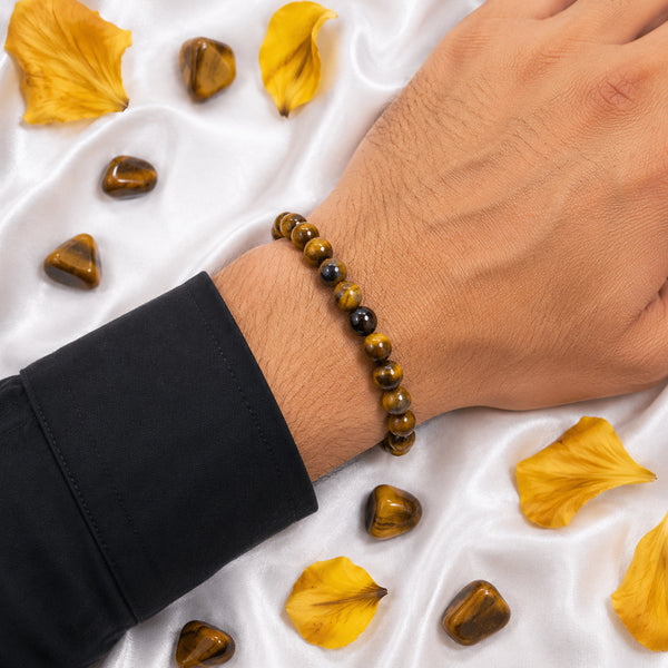 A person wearing the multi-color Tiger's Eye bead bracelet, showcasing its natural shimmer and comfortable stretch fit.
